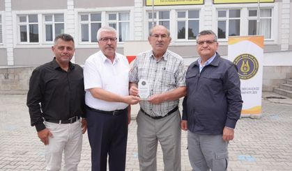OSMAN AKSU’YA ANLAMLI PLAKET